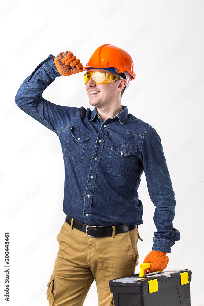 Portrait of repairman (builder) in helmet and with tool box in hands isolated on white background. Portrait of repairman (builder) in helmet and with tool box in hands isolated on white background.