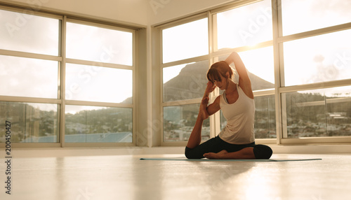Woman doing yoga at fitness studio