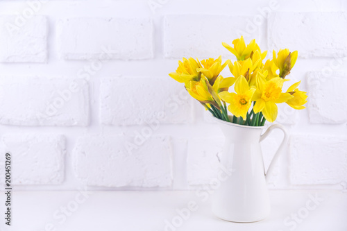 Fototapeta Naklejka Na Ścianę i Meble -  Jar with narcissuses at the white background. Spring, mothers day and easter concept