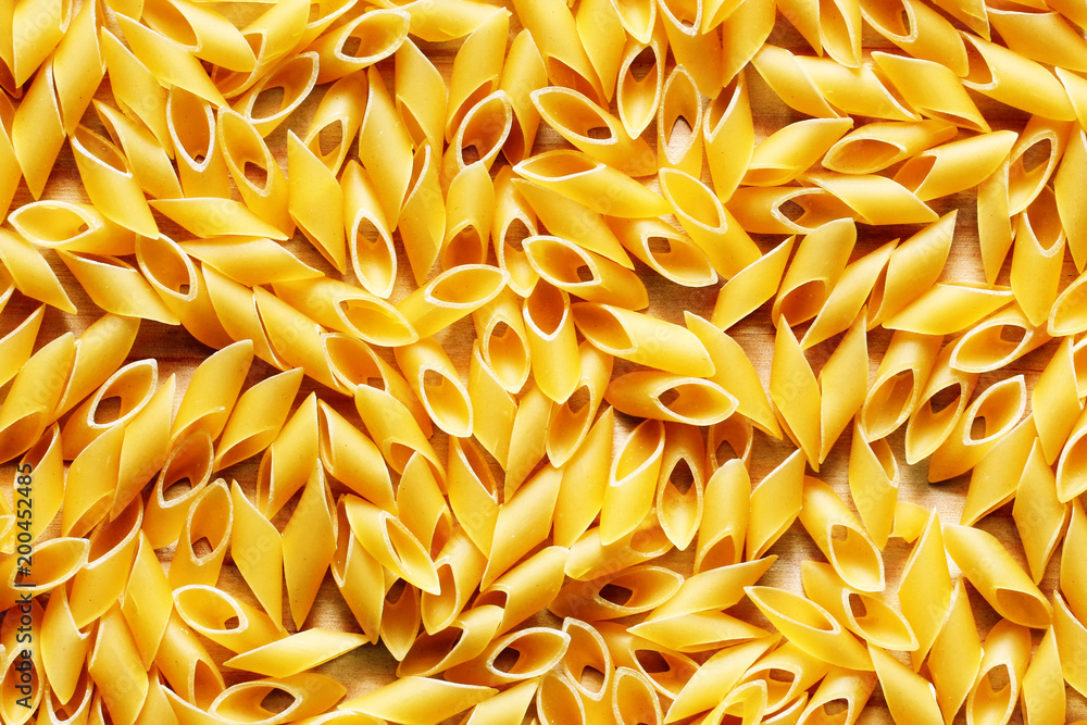 Yellow pasta close up on wood Yellow pasta close up on wood