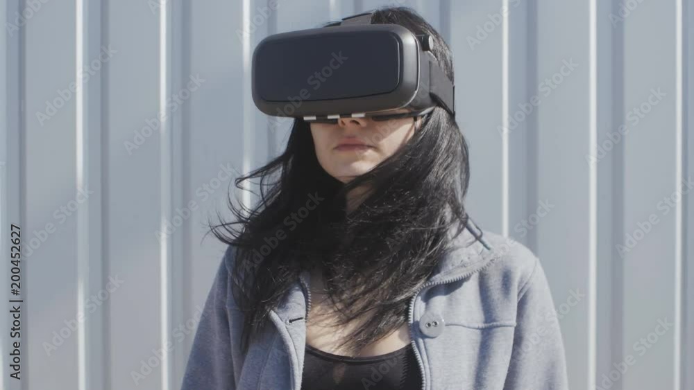 Young woman using virtual reality headset outdoor Young woman using virtual reality headset outdoor