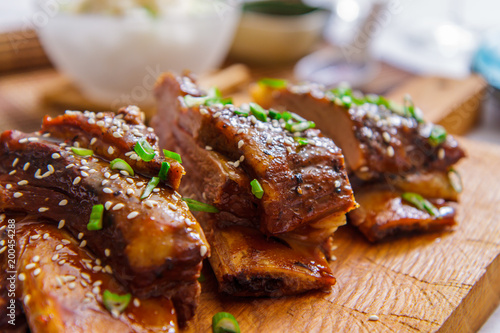 Grilled beef ribs and white rice in a glass bowl close-up. Asian cuisine