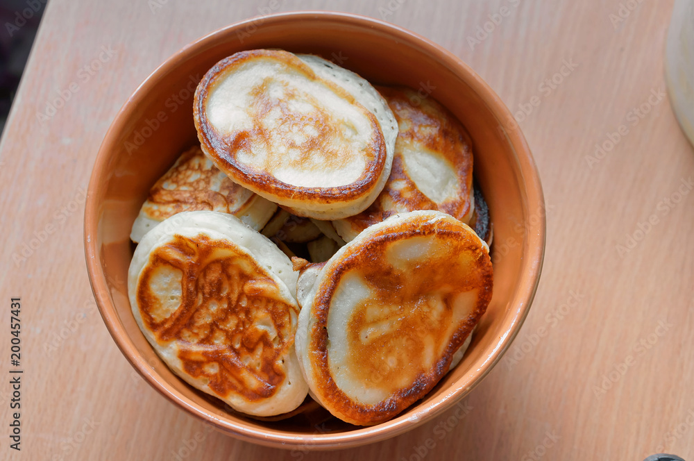 Pancakes in a deep bowl. Fragrant pancakes in a plate. Round small pancakes in a deep plate. Pancakes in a deep bowl. Fragrant pancakes in a plate. Round small pancakes in a deep plate.