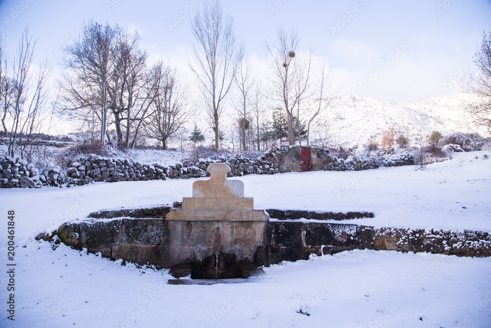 Snowy landscape with fountain in Ocenilla village in Soria Spain Snowy landscape with fountain in Ocenilla village in Soria Spain
