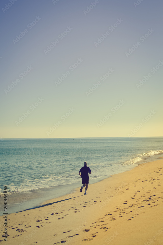 Unrecognized active sporty people happy running on the beach ecean shore sunny day outdoors background, vitality healthy motion lifestyle activity