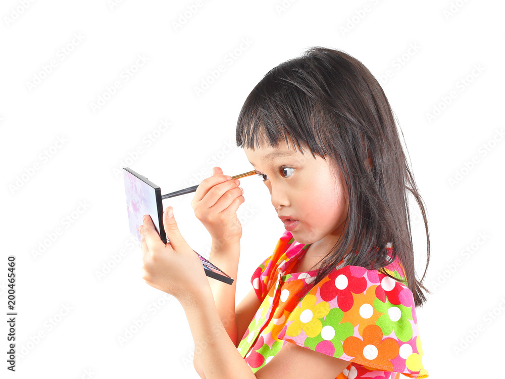 Asian little girl applying make up. Mascara, eye shadow, Asian little girl applying make up. Mascara, eye shadow,