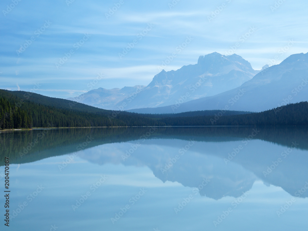 Fototapeta premium Mountains reflected in calm lake