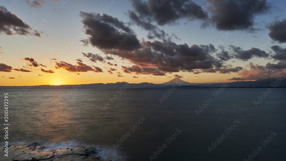 Long exposure of dramatic clouds over Mount Fuji at sunset, Kanagawa Prefecture, Japan