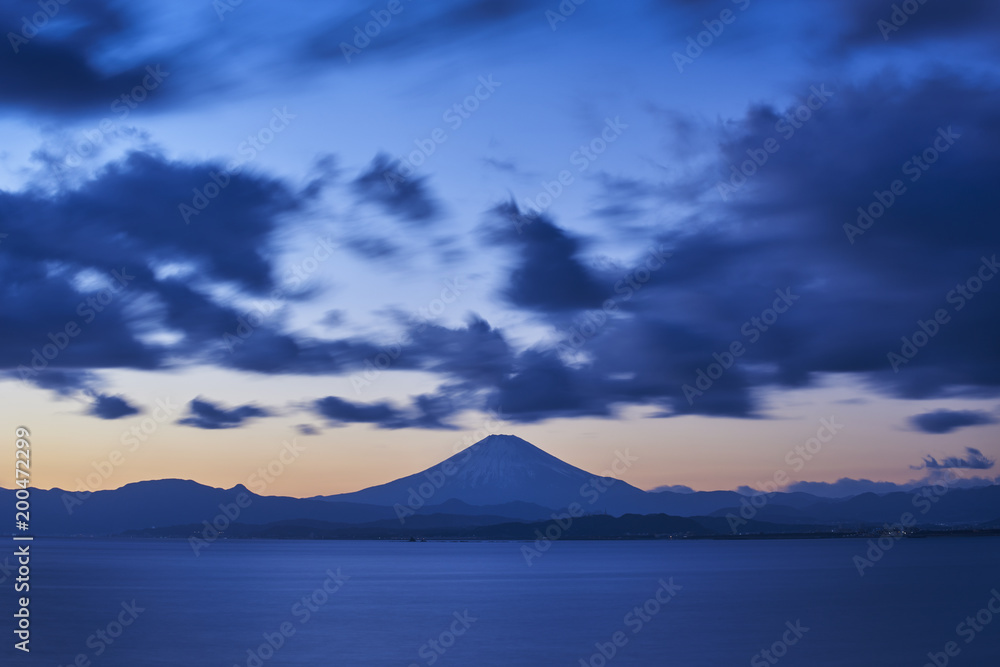 Long exposure of dramatic clouds over Mount Fuji after sunset, Kanagawa Prefecture, Japan