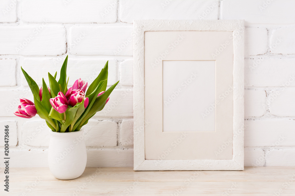 White frame mockup with magenta pink tulip in the flower pot White frame mockup with magenta pink tulip in the flower pot