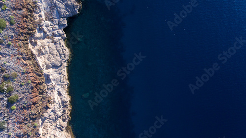 Sand  rock  and sea patterns on cristal clear waters.