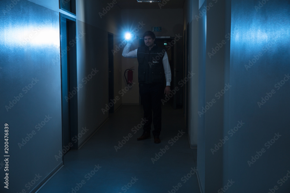 Security Guard Holding Flashlight
