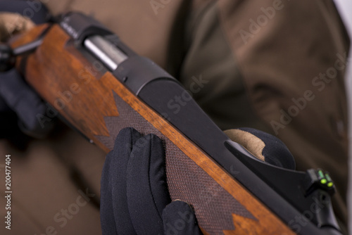 the hunter's gun in his hands