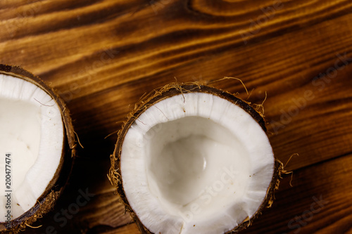 Fresh ripe coconut on rustic wooden table