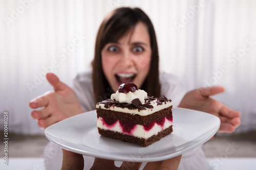 Woman Taking Slice Of Cake