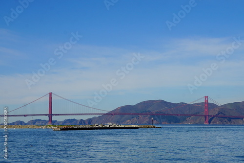 Golden gate bridge with mountain background.