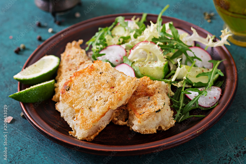 Fried white fish fillet and cucumber and radish salad