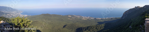 Stunning panoramic view opening to the mountains and the sea of the Crimean peninsula by a summer cloudless day.