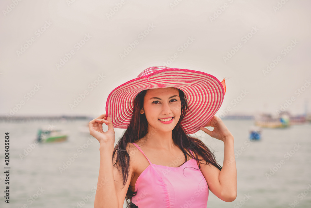 Travel Concepts. Beautiful girl relaxing on the beach. Beautiful girl is happy to come to the beach. Beautiful girl is walking the beach. Happy women and relaxing on the seashore.