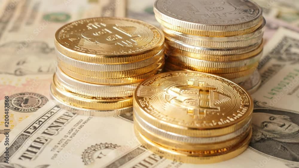 rotating piles of cryptocurrency coins on dollars, shining bitcoin, concept rotating piles of cryptocurrency coins on dollars, shining bitcoin, concept