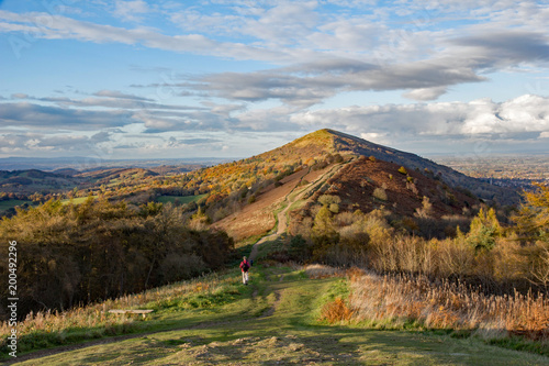 Konstfotografi Impressive ridge of the Malvern hills, Worcestershire, England, showing a person walking on a footpath to the summit
