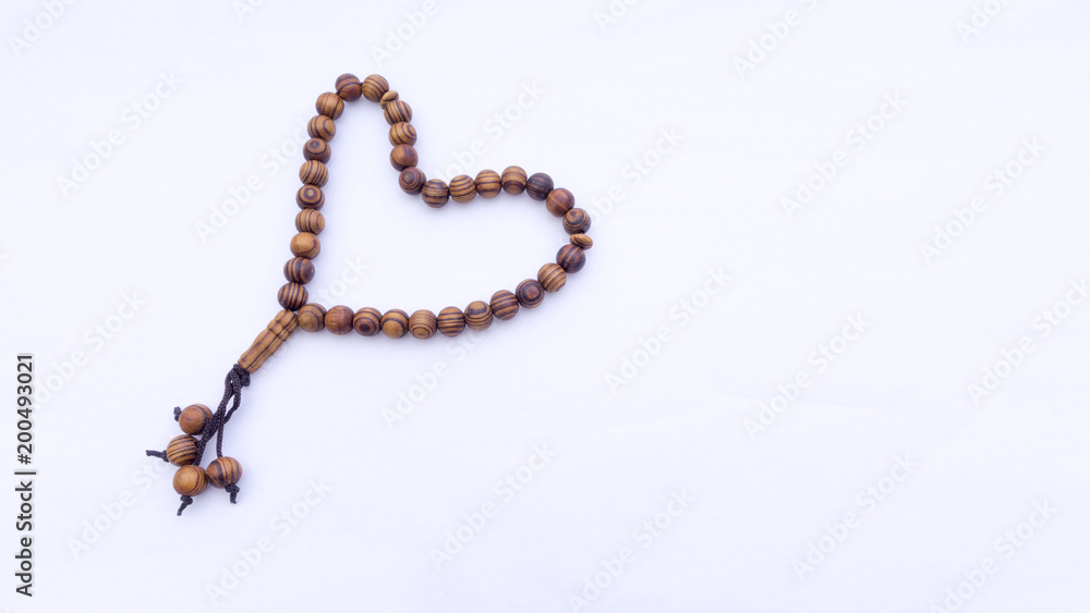 Closeup of tasbih or rosary on a white background. Selective focus and copy space. Closeup of tasbih or rosary on a white background. Selective focus and copy space.