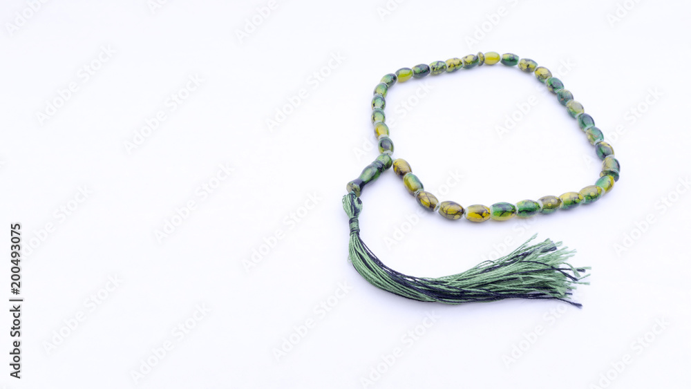 Closeup of tasbih or rosary on a white background. Selective focus and copy space. Closeup of tasbih or rosary on a white background. Selective focus and copy space.