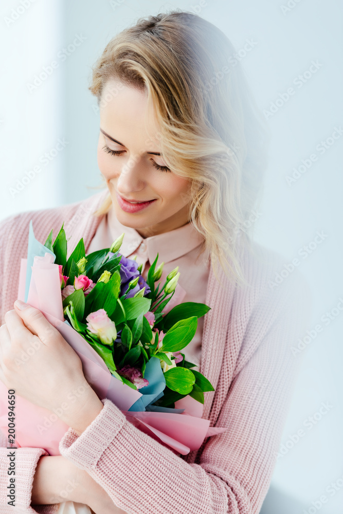 portrait of beautiful smiling woman with bouquet of flowers