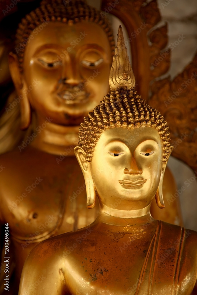 Close up of the head of a gold Thai Buddha statue, Bangkok, Thailand.