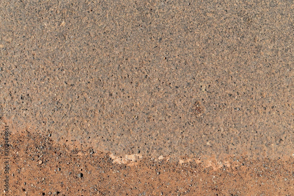 surface of old asphalt road and soil in countryside surface of old asphalt road and soil in countryside