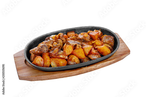 Potato with mushrooms and onions, fried, baked portion on a hot frying pan, on a wooden board on a white isolated background Side view. For the menu, restaurant, bar, cafe photo