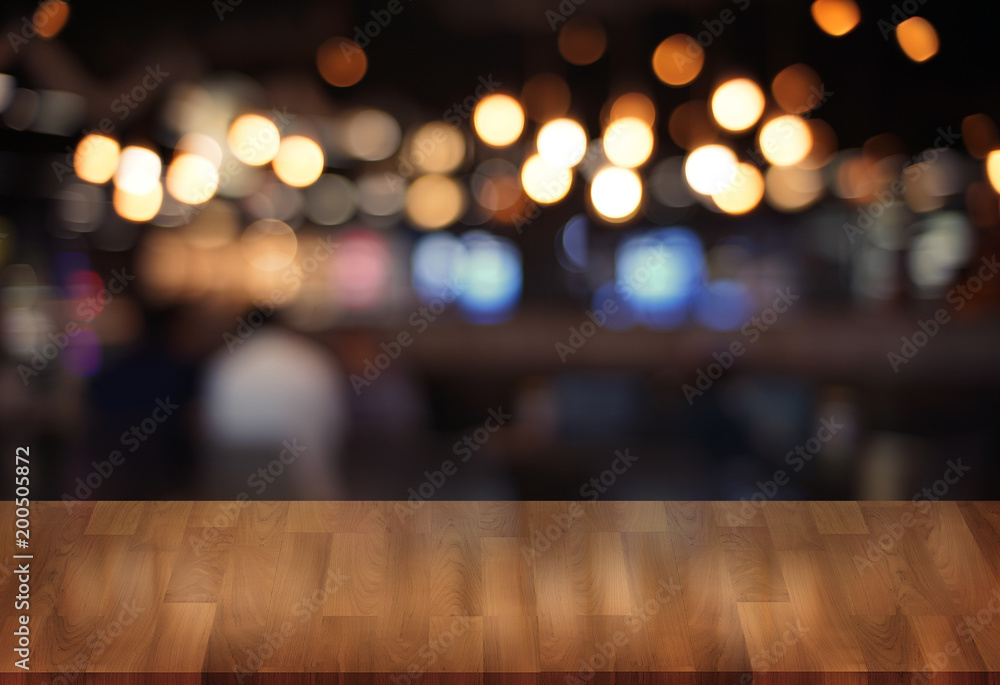 Wooden board empty table  cafe, coffee shop, bar blurred background can be used for display or montage your products and Mock up