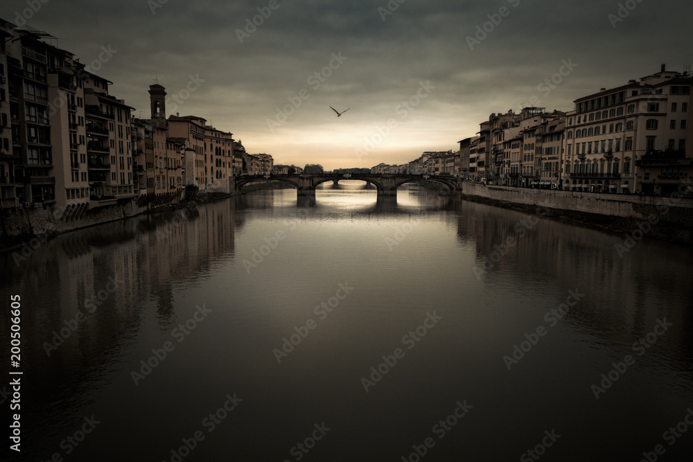 Florence Arno river under a moody sky at dusk
