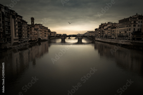 Florence Arno river under a moody sky at dusk 