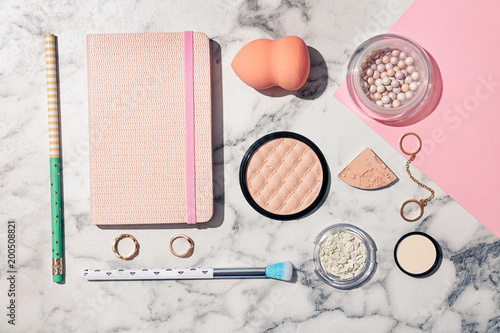 Flat lay composition with cosmetic products and notebook on light background