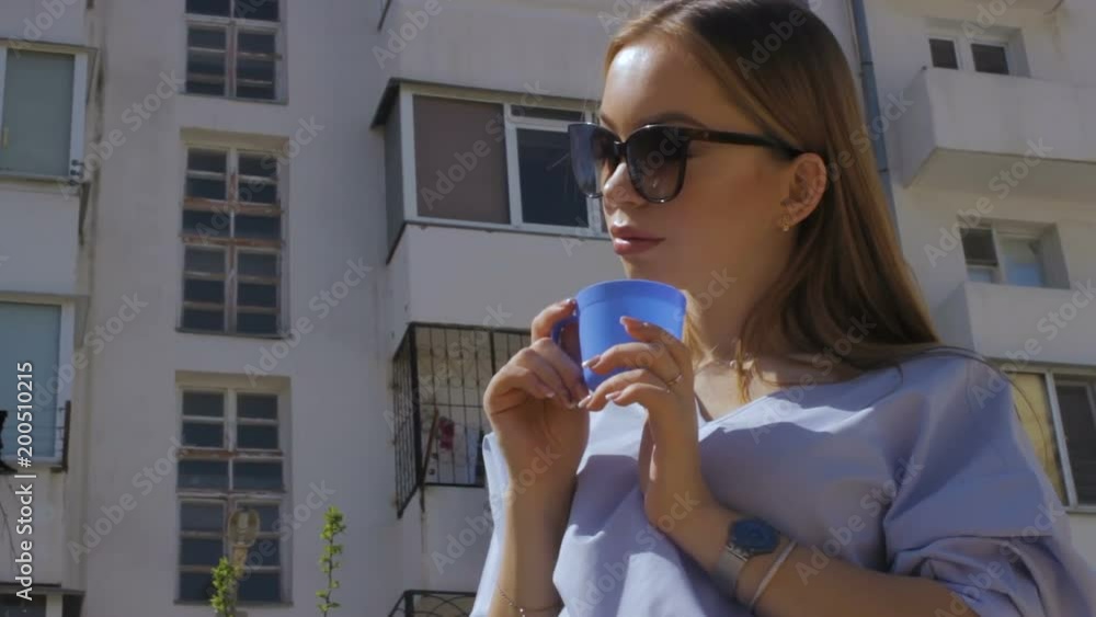 Pretty young woman drinks coffee, street Pretty young woman drinks coffee, street