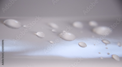 water drops on gray surface with color gradient