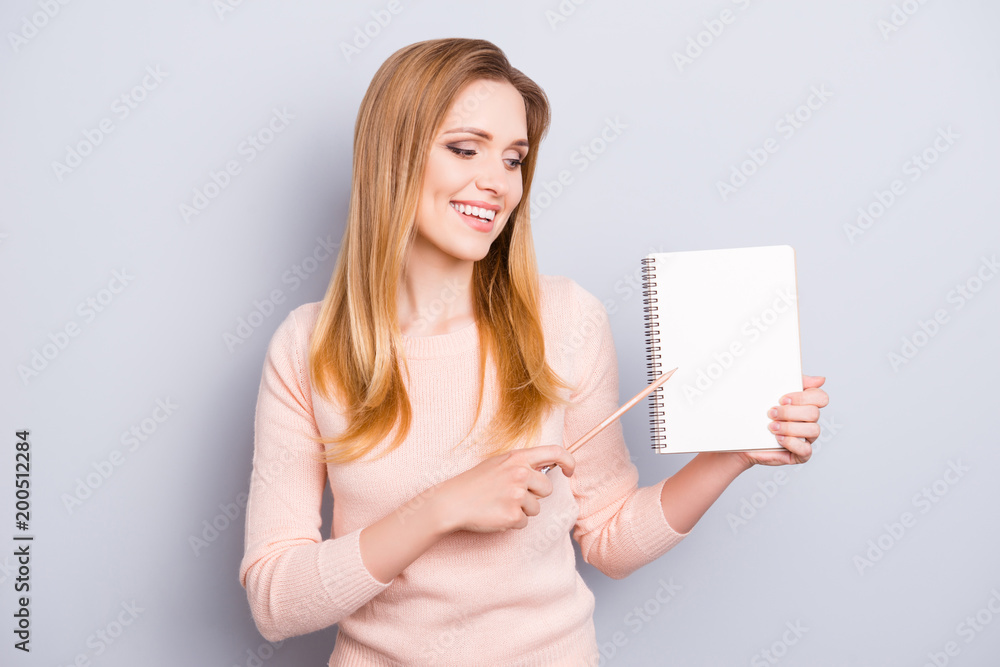 Tips list to do memory people person concept. Portrait of charming pretty smart confident clever lady demonstrating empty blank space in notebook isolated on gray background copyspace Tips list to do memory people person concept. Portrait of charming pretty smart confident clever lady demonstrating empty blank space in notebook isolated on gray background copyspace