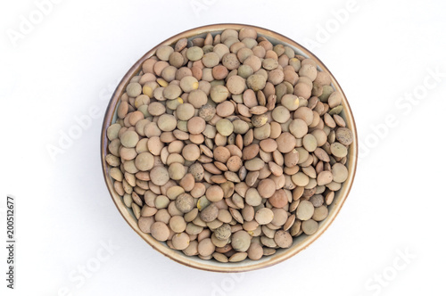 group of raw lentils in a bowl on white background