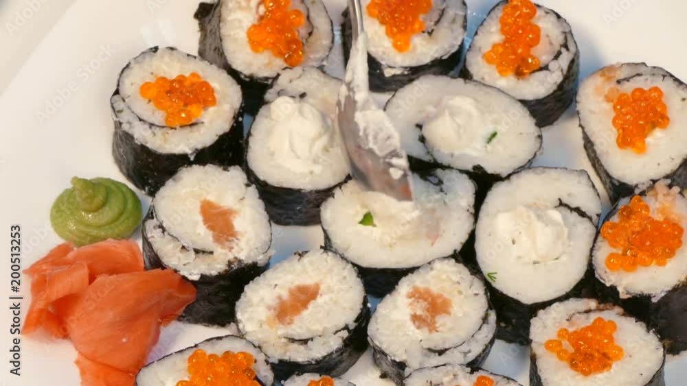 To decorate sushi with red caviar and cheese. To decorate sushi with red caviar and cheese.