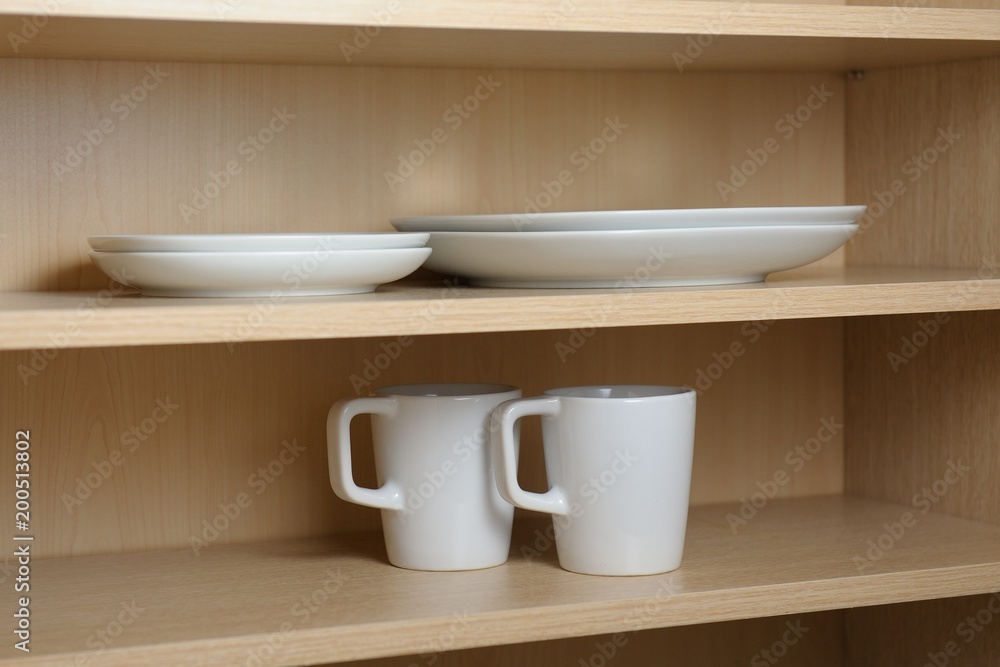 Kitchen cupboard with white cups. Live at home with my husband and wife. live together. Scandinavian style Kitchen cupboard with white cups. Live at home with my husband and wife. live together. Scandinavian style