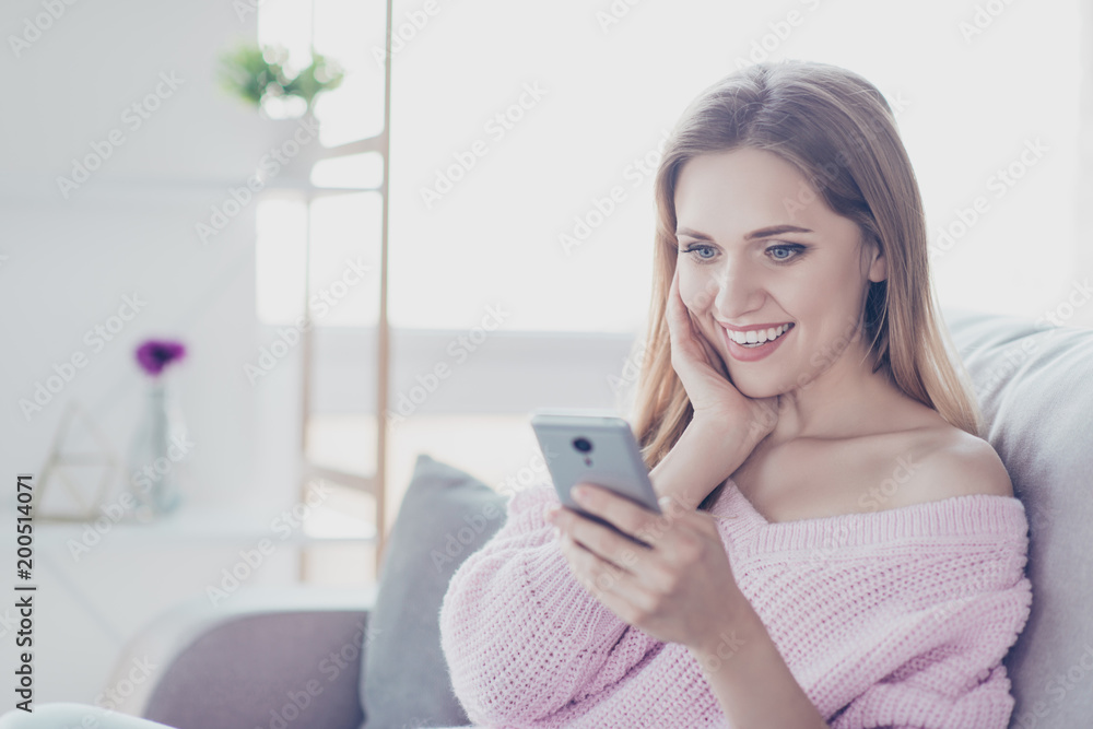 People person emotion expressing feeling unbelievable joy fun enjoy concept. Close up portrait of romantic charming excited cheerful pretty lady using mobilephone sitting on divan knitted pullover People person emotion expressing feeling unbelievable joy fun enjoy concept. Close up portrait of romantic charming excited cheerful pretty lady using mobilephone sitting on divan knitted pullover