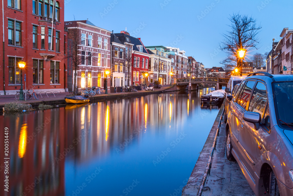 Cityscape - evening view of the city canal with bridge and boats, the city of Leiden, Netherlands