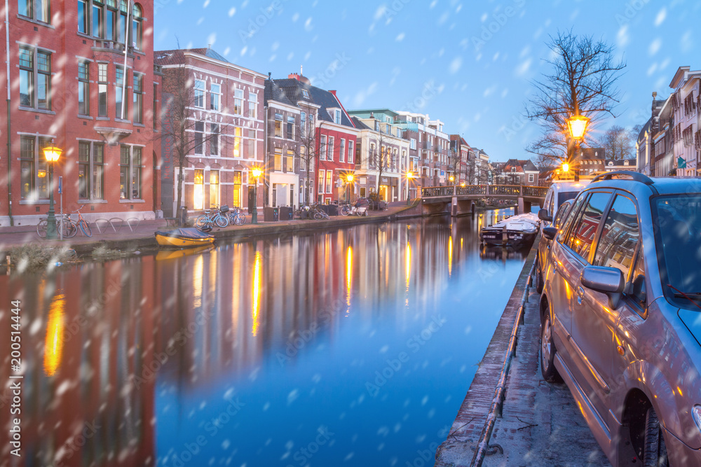 Cityscape - winter view of the city canal with bridge and boats, the city of Leiden, Netherlands