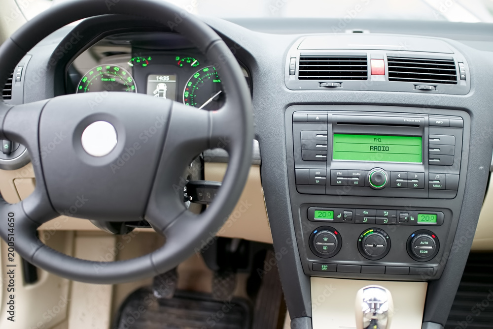 Modern car dashboard, steering wheel, radio system and climate control panel