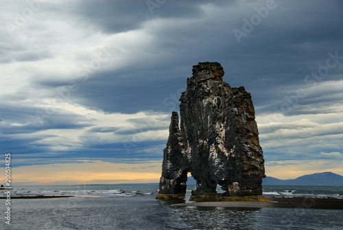 Iceland. Rock in the sea. The last dinosaur of the planet Earth