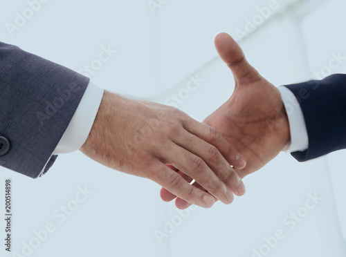 Two business men going to make handshake