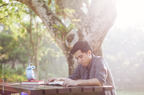 Young man studying alone at a park