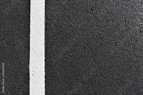 dirty white line on surface of old asphalt in countryside