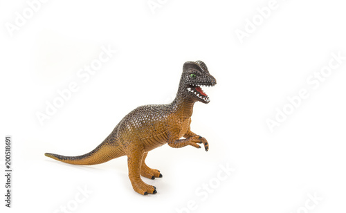 Dinosaur toy with open mouth on the white